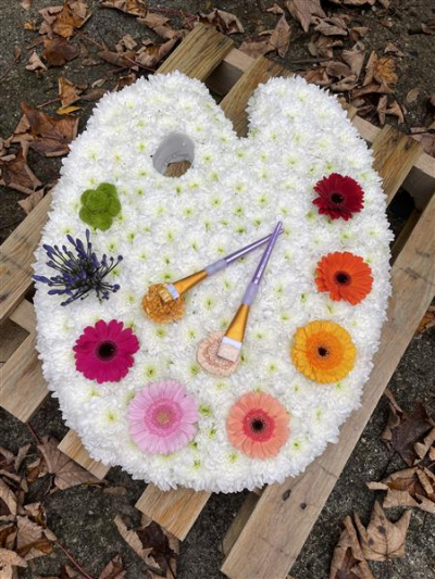 Bespoke tribute - Artists Painters Palette Funeral Flowers
A handmade artists painters palette created using double white Chrysanthemums for the base along with 8 splashes of colour designating different shades of paint.